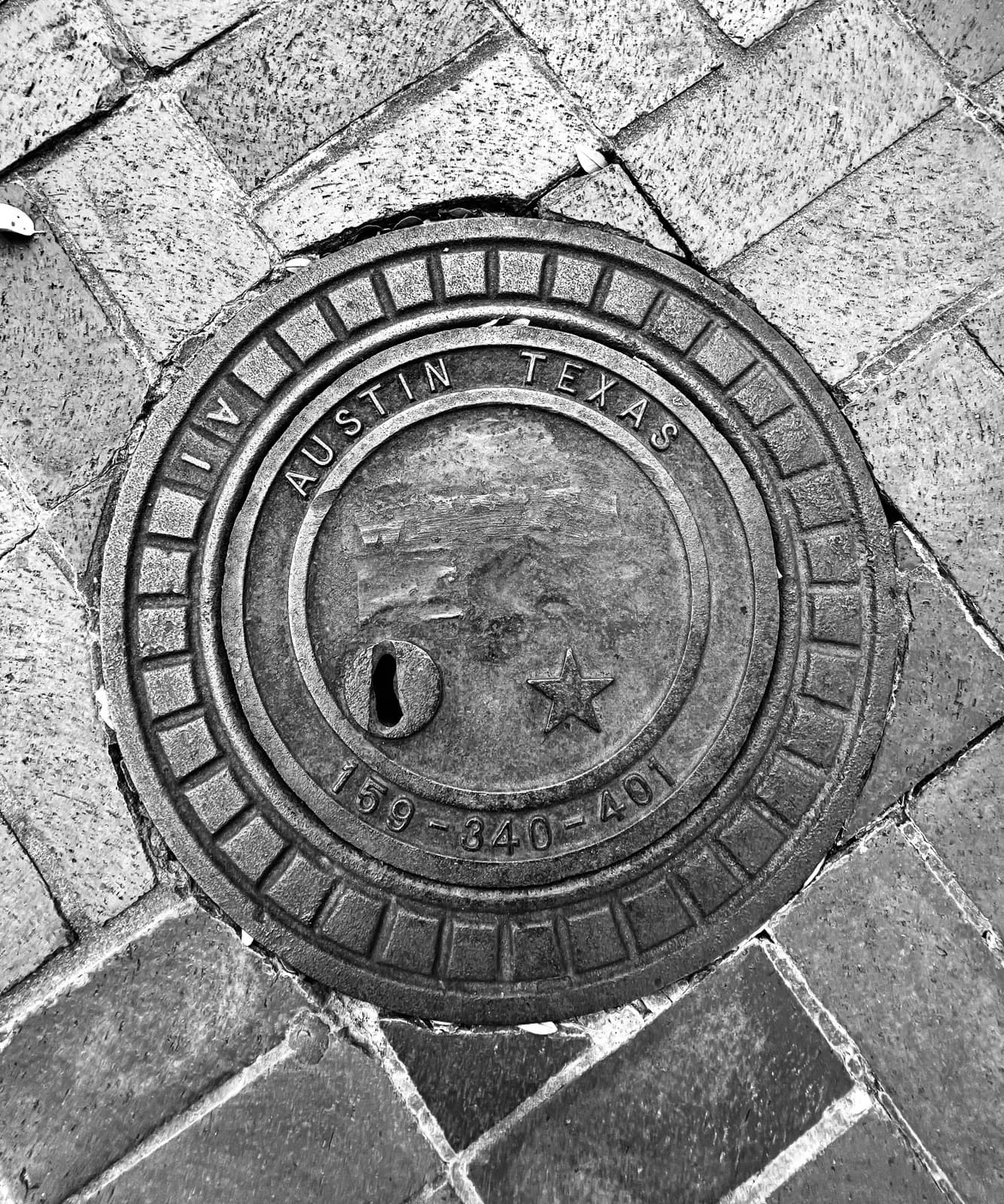 Austin Texas lettering on a street utility cover