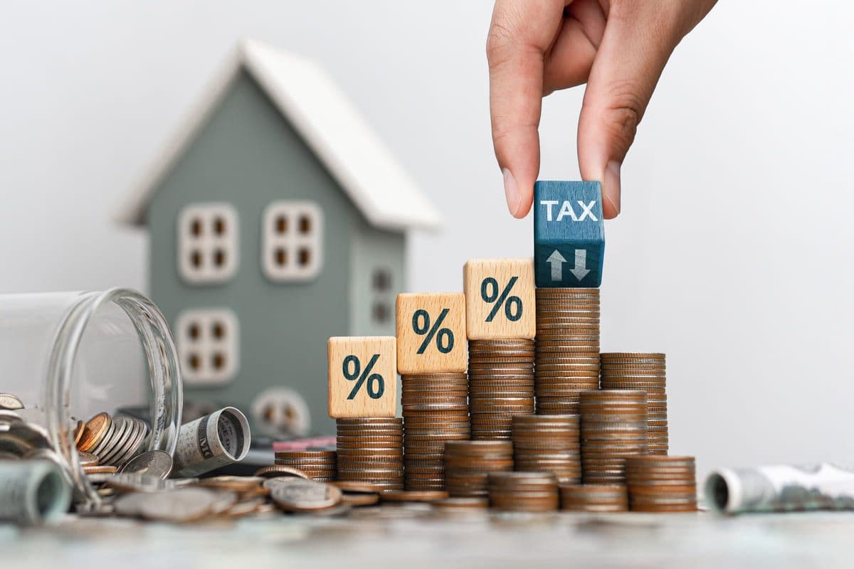Property Tax Concept with Coins and Toy House
